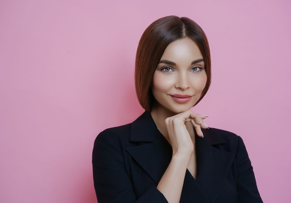 A confident person smiling broadly after a cosmetic veneer treatment
