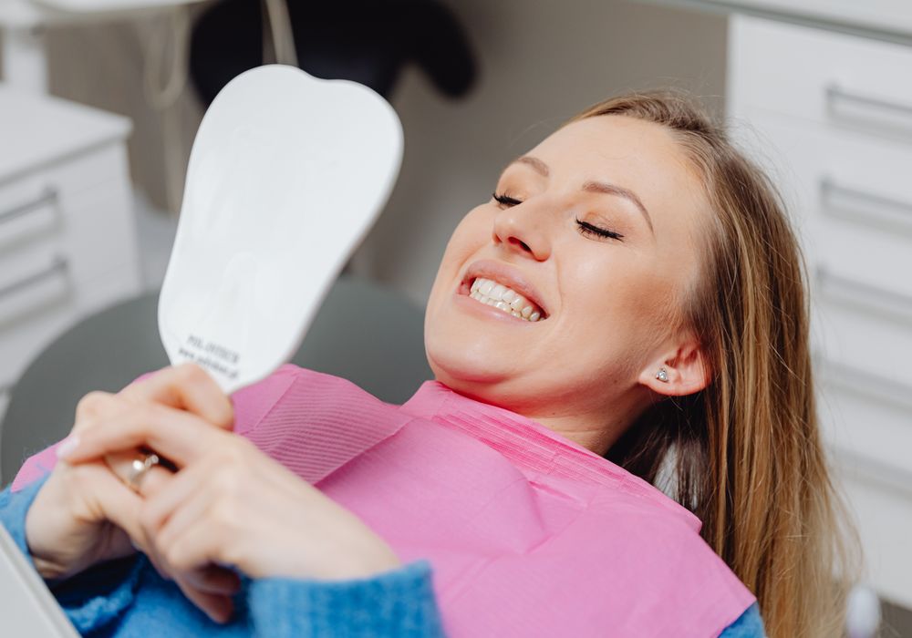 A patient with a bright, healthy smile after whitening treatment